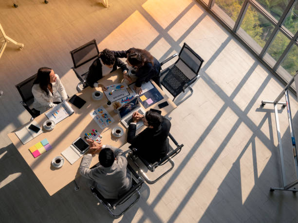 business woman advise partner during meeting high angle view of business woman advise patner with empathy during meeting session in office, diversity business people, financial discuassion, good relationship in work place real estate office stock pictures, royalty-free photos & images