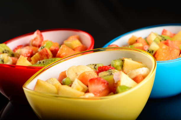 fruit salad in colorful bowls.