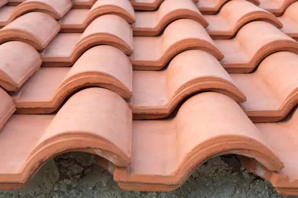 Detail of a red clay roofing tiles, construction with overlapping tiles, Mediterranean style, Croatian house