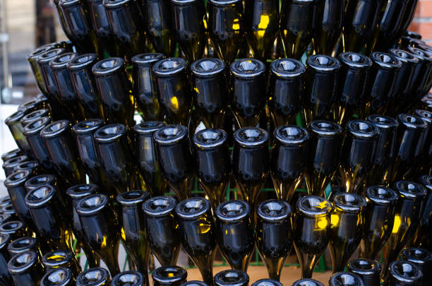 istock Empty wine bottles. Alcohol containers. Sculpture from bottles. Colored glass. 1298165037
