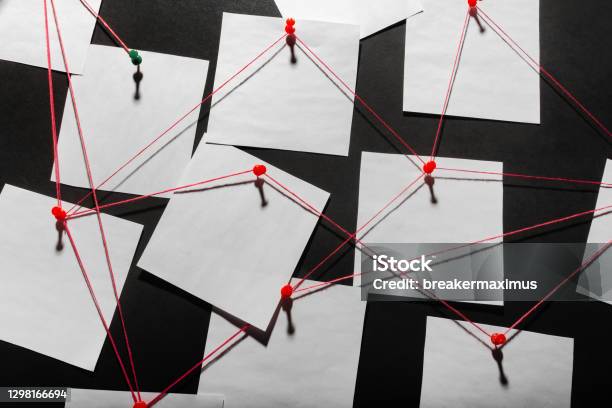 Black Detecftive Board With Blank Paper Linked By Red Thread Stock Photo - Download Image Now