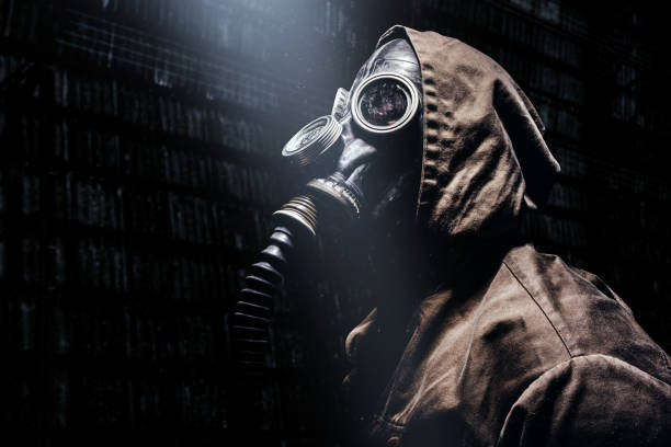 istock Stalker warrior in protective soviet gas mask standing in tunnels. 1298167354