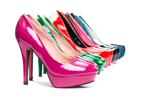 Close-up studio shot  of various stiletto high heels in different colors, lots of copy space.