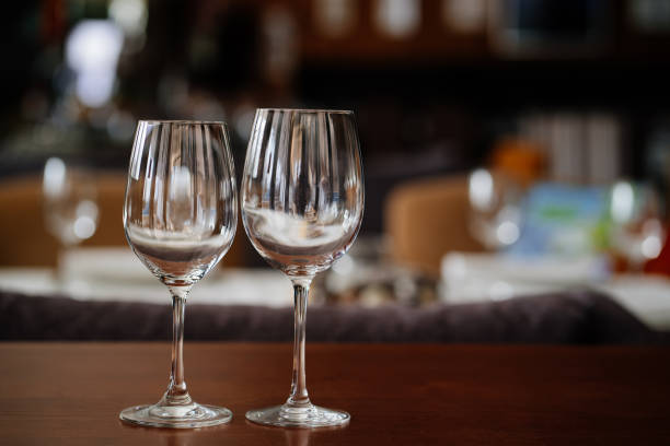 istock two empty clean wine glasses on a wooden table. utensils for alcoholic beverages 1298171024