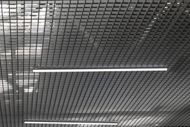 istock LED lighting lamp on the ceiling of an commercial building. Grid ceiling make nice architectural interior false ceiling view or design for shopping mall and office building 1298171087