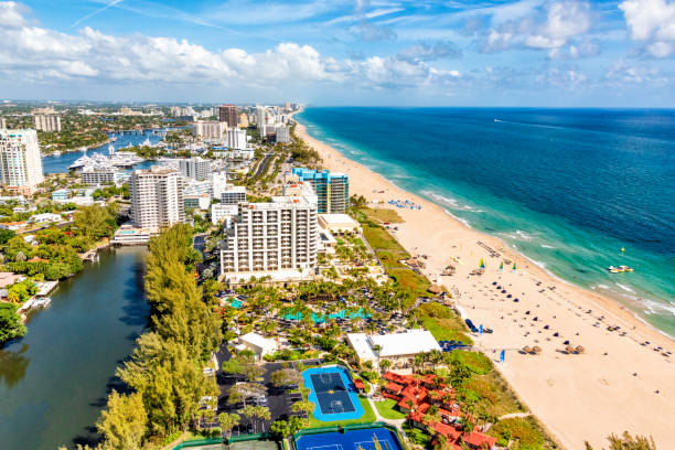 beach resort background with sand and surf in foreground room for copy