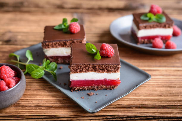 istock Delicious chocolate raspberry cheesecake, topped with chocolate frosting 1298174026