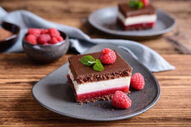 istock Delicious chocolate raspberry cheesecake, topped with chocolate frosting 1298174037