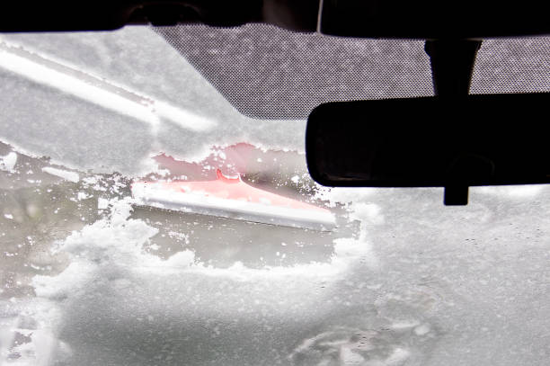 istock Cleaning car after snow storm 1298176175