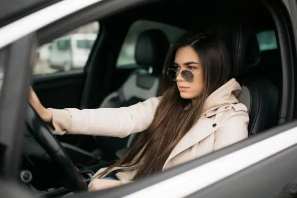 Photo of Beautiful young Caucasian woman driving a car