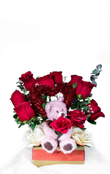 istock Red roses bouquet with red heart shape and teddy bear. 1298176792
