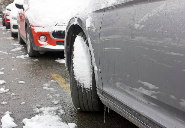 istock Car tires on winter road covered with snow 1298176896