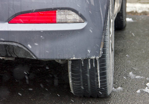 istock Car tires on winter road covered with snow 1298179880