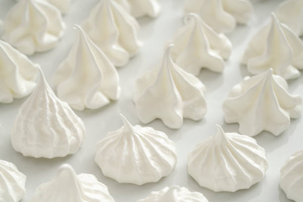Meringue kisses in white homemade with egg white on white background