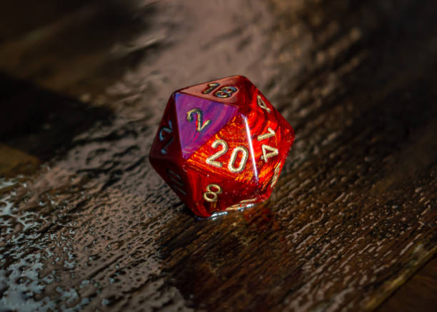istock Marbled red 20 sided dice on a wet wooden surface 1298181180