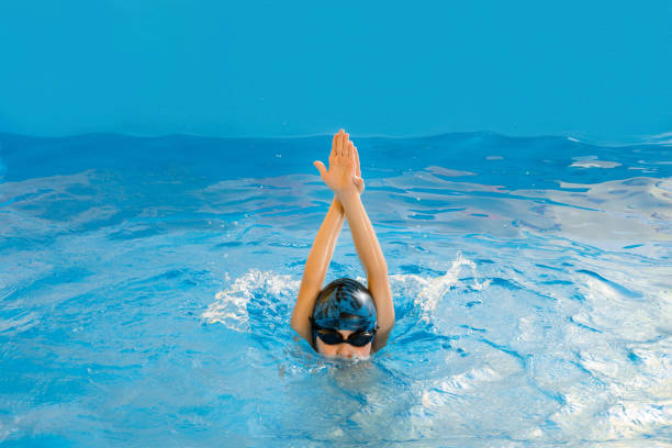 istock Boy swimming in indoor pool having fun during swim class 1298181236