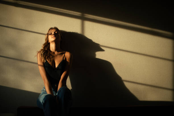 istock Beautiful young woman waking up under the morning light 1298181299