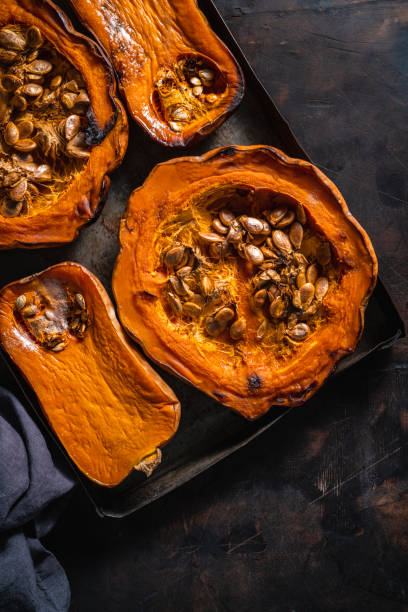 istock Pumpkin and butternut squash roasted oven on dark wooden background 1298182149