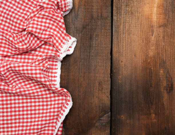 istock red kitchen towel on brown wooden background, top view 1298182639