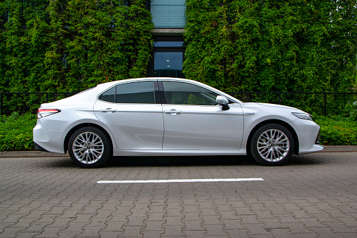 Berlin, Germany - 10 July, 2019: Toyota Camry Hybrid on a street. The Camry is one of the most popular sedan vehicles in the world.