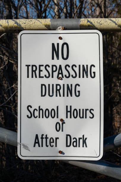 istock No trespassing during school hours or after dark sign 1298185818
