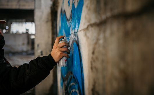 Graffiti Writer Spraying on Wall