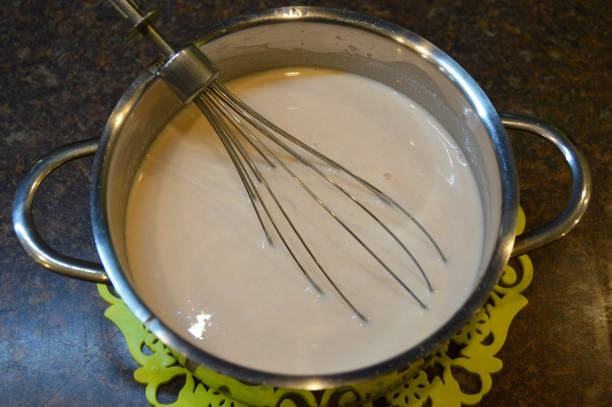 istock sour cream tomato sauce in a saucepan 1298186734