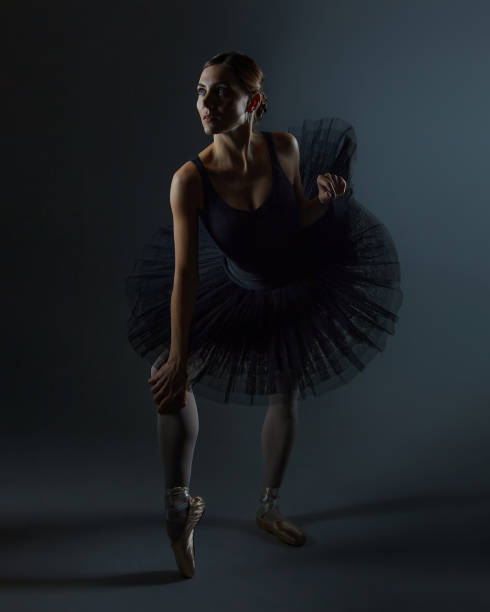 istock attractive ballerina poses gracefully in the studio on a black background 1298188915