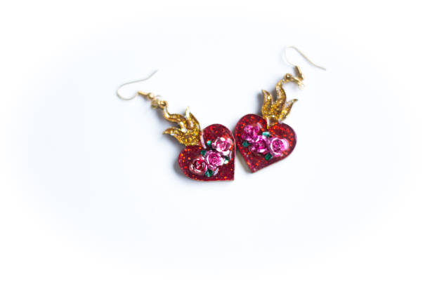 istock Two Red Heart Earrings Touching, White Background 1298188962