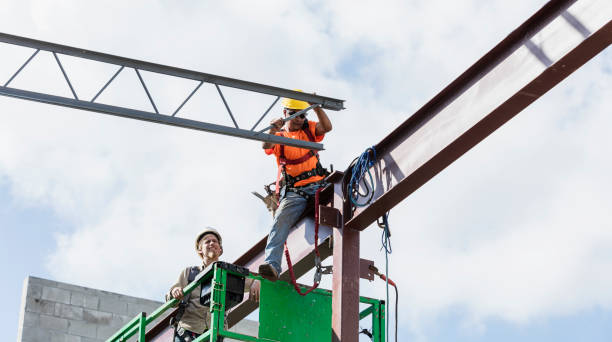 istock Ironworkers at construction site installing roof joist 1298191557