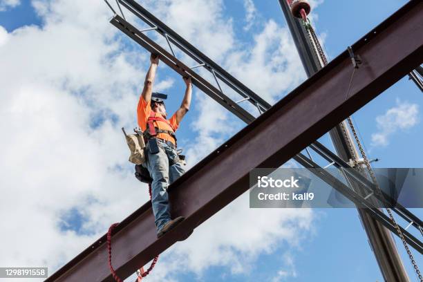 Ironworker At Construction Site Installing Roof Joist Stock Photo - Download Image Now