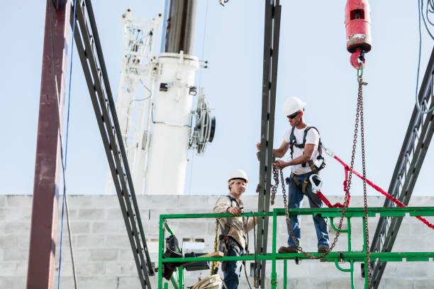 istock Steel workers installing roof trusses 1298192105