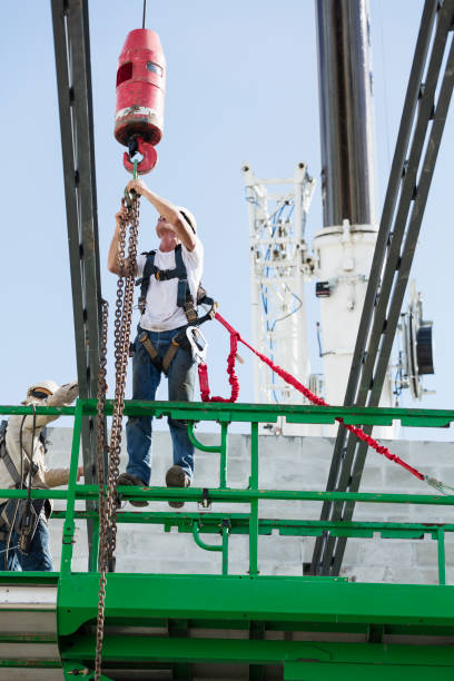 istock Steel workers installing roof trusses 1298192130