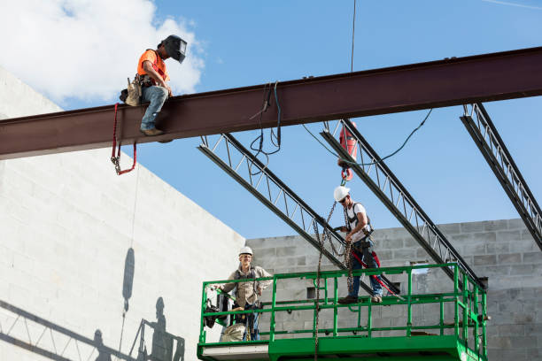 Crew installing roof joists at construction site