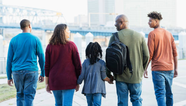 istock Family walking along city waterfront 1298192522