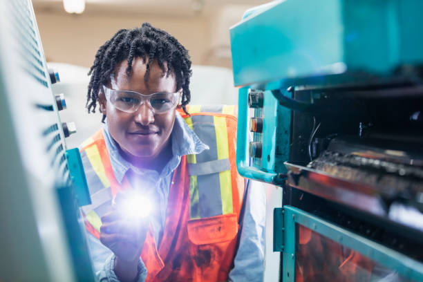 istock Black woman inspecting printing press 1298192599