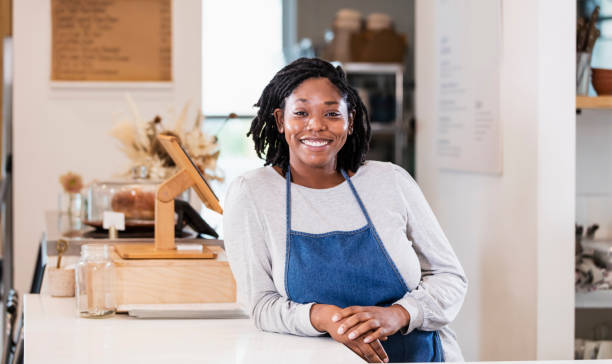 istock Young woman working in cafe at checkout 1298193179
