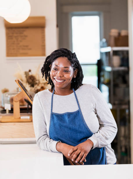 istock Young woman working in cafe at checkout 1298193180