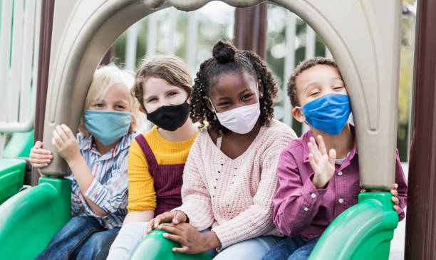 istock Children on playground wearing face masks, COVID-19 1298193309