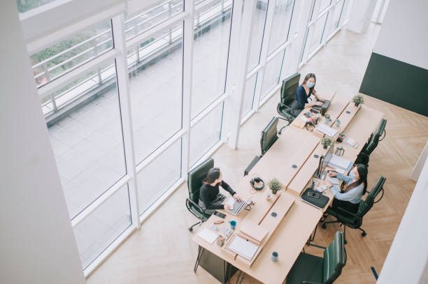 istock asian chinese beautiful women with protective facemask working in open plan office observing with new SOP and social distancing illness prevention safety precautions 1298198137
