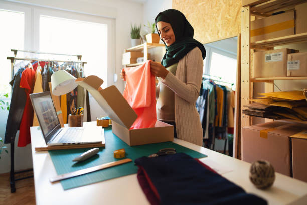 istock Young Muslim woman working in a e-commerce small business workshop 1298198888