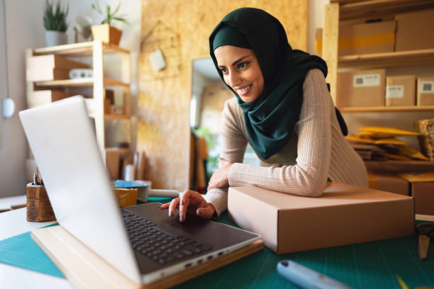 istock Smiling Muslim woman doing e-commerce business from home office 1298198894