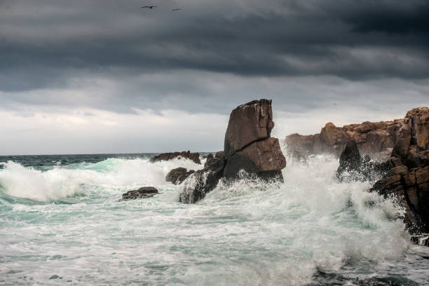 istock Powerful waves crashes in rocky coastline 1298198980