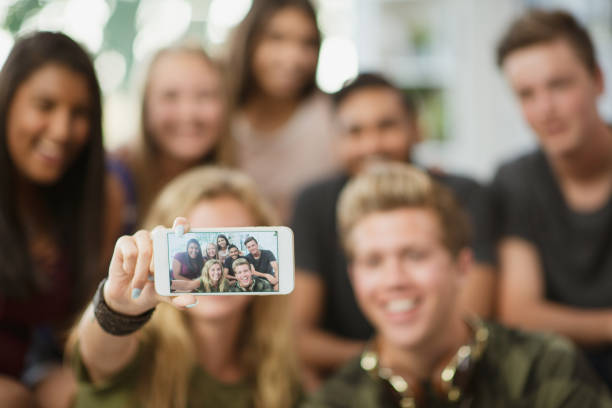 istock Teenagers taking selfies together 1298199564
