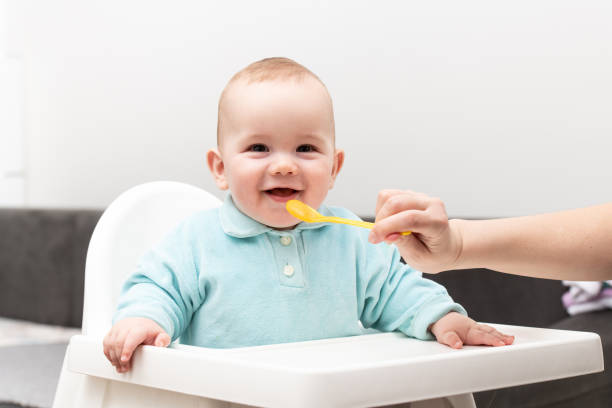 istock Baby Child Eating In Chair 1298200027