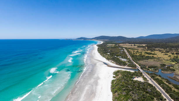 istock Stunning high angle aerial panoramic drone view of Denison Beach, Denison River and the A3 Tasman Highway just north of the village of Bicheno on the east coast of Tasmania, Australia on a sunny day. 1298200758