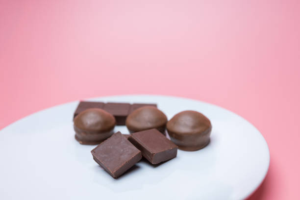istock Valentine dark chocolate on pink background, Valentines Day Theme 1298202463