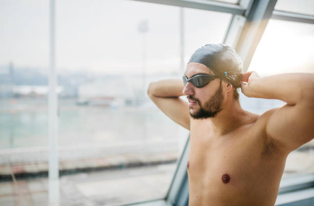 istock Swimmer preparing goggles for swimming 1298204107