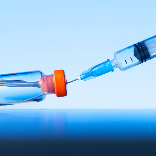 istock Medical syringe with a vaccine. Concept vaccination. 1298205095