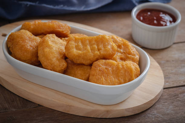 istock Fried crispy chicken nuggets and ketchup sauce in bowl 1298205184